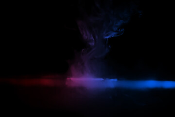 Wall Mural - colorful smoke on dark background. Color steam on a black background. Red and blue smoke. Copy space.