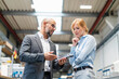 © Westend61 - Businessman and businesswoman examining workpiece in factory