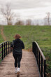 © Ljustina - Young sportswoman running on wooden bridge in countryside