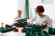 © Westend61 - Mother and daughter doing crafts at home with accessories to make a Christmas tree