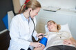 © Westend61 - Female doctor taking blood pressure of patient in medical practice