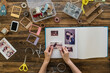 © Westend61 - Top view of woman's hands designing photo album