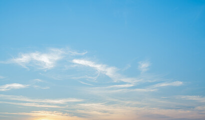 Wall Mural - the sky is clear with fiuffy wthite clouds and beautiful orange light.