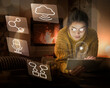 © Westend61 - Young woman using tablet at home surrounded by internet symbols