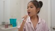 © FAMILY STOCK - Morning routine, smiling happy Asian girls brushing teeth with a toothbrush. Dental hygiene of little girls, medical care.