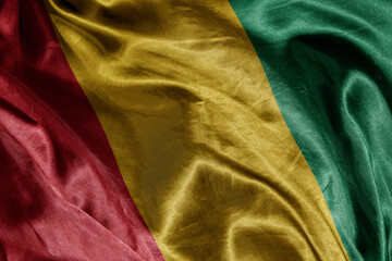 Wall Mural - shine waving colourful realistic national flag of guinea . macro shot