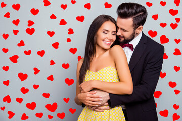 Aufkleber - Photo of beautiful, cheerful, positive, cute, sensual, tender couple enjoying hugs with each other having eyes close over grey background with copy space, gentle husband's hands touch his wife