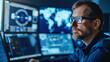 © Vilaysack - focused air traffic controller monitoring multiple screens in control tower, analyzing global flight data and radar systems with precision and concentration