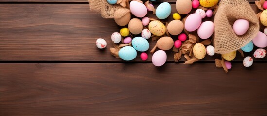 Colorful Easter eggs scattered on a rustic wooden surface with paper bags, featuring pastel shades of pink, blue, yellow, and brown elements.