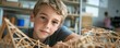 © Sanych - Caucasian boy engaged in creative stem project with wood structures in classroom setting
