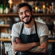 © Coosh448 - Smiling hispanic male bartender in casual attire at cozy bar counter
