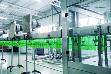 Poster - equipment at beverage production facility showcasing automated bottling process during daylight hour