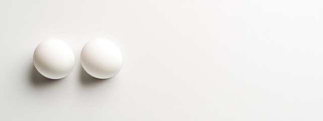 Poster - Two white spherical objects on a minimalist white background with ample copy space for text or graphic design elements.