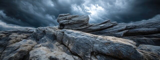 Poster - Moody skies above rugged stones create a dramatic landscape with ample space for text or creative elements in various media projects