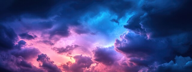 Poster - dramatic blue purple and pink stormy clouds in a moody night sky with ample copy space for text or c
