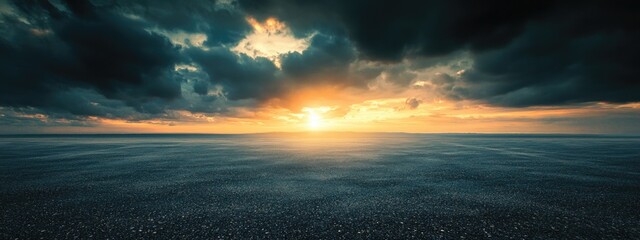 Poster - Dramatic sunset clouds over tranquil asphalt road with ample space for text and visuals in a serene atmosphere