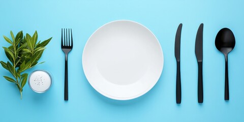 Aufkleber - Elegant Table Setting with Black Cutlery and Fresh Greenery on Blue Background for Fine Dining Themes and Restaurant Promotions