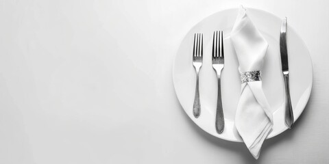 Poster - Sophisticated dining arrangement featuring silver cutlery and white napkin on a clean plate with ample space for text or branding.