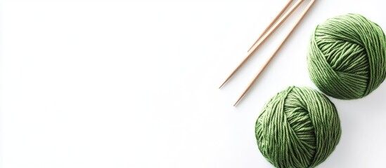 Wall Mural - Green Yarn Balls and Knitting Needles on White Background with Space for Text Showcasing Cozy Crafting Materials for Knitting and Crochet