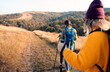 © Zoran Zeremski - Two smiling woman hiking at top of the hill at meadow.