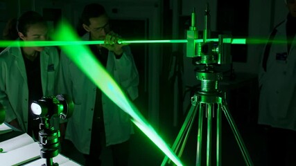 Leinwandbilder - Exploring laser technology during experiments in a scientific laboratory in the evening