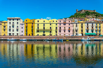 Wall Mural - View of colorful houses with water reflections in the Temo river in the old town of Bosa, Sardinia island, Italy