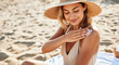 © Running opossum - Tourist applying sunscreen protection cream on her shoulder, enjoying summer holidays at the beach
