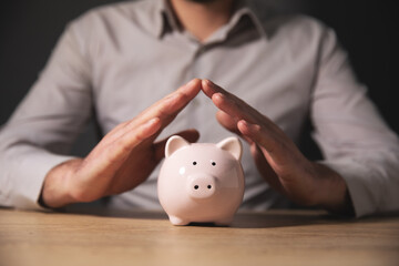 Wall Mural - hand of man with piggy bank