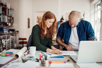 Diverse architects working together on project in modern office