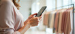 © Radorog. - a woman with a phone in her hands in a women's clothing store