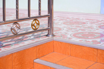 Wall Mural - Row of silver and golden stainless steel fence on tile floor with stair on entrance way of vintage house