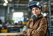 © Dmitry - Woman welder in protective helmet at industrial workshop. Female worker in brown uniform. Professional craftswoman at manufacturing plant. Modern industry and skilled labor concept