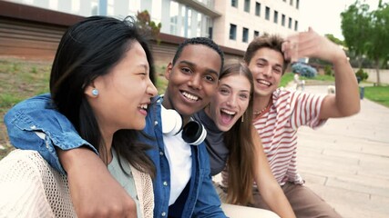 Wall Mural - Happy joyful group of friends taking a selfie smiling. Multicultural young carefree people having fun and taking pictures outside.