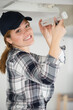 © auremar - female electrician installing neon bulb