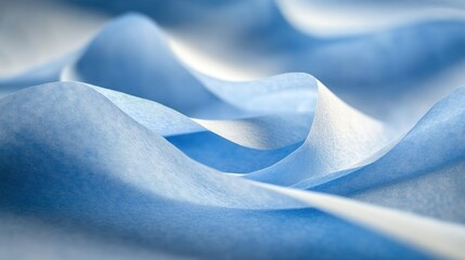 Poster - Soft, flowing blue fabric drapes elegantly, revealing smooth curves and delicate shadows