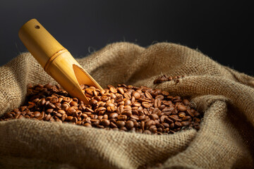 Wall Mural - Roasted coffee beans in burlap bag.