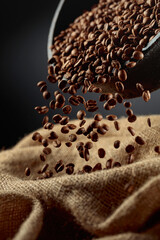 Wall Mural - Freshly roasted coffee beans are poured into a bag.