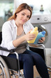 © auremar - disable woman holding wash product doing laundry