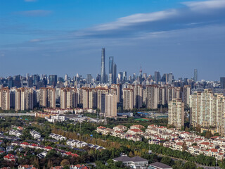 The drone aerial view of residential district in Pudong with skyscrapers in the background, Shanghai, China.	