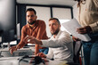 © Zamrznuti tonovi - Software developers team working on project and discussing about programming code at office desk