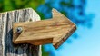 © Aleksandar - A rustic wooden arrow sign with a weathered look directs attention to the right, set against a vibrant blue background that evokes a sense of exploration and direction.