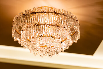 Chandelier with a gold frame and clear crystals hanging from it