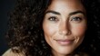 © imagineRbc - A woman with beautiful curly hair and radiant skin is smiling softly, highlighting her freckles and expressive eyes. The soft lighting adds warmth to her joyful expression
