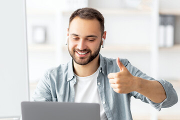 Poster - Happy male teacher giving English lesson on web using laptop, gesturing thumb up, recommending foreign languages school. Millennial tutor lecturing over internet from home during covid lockdown