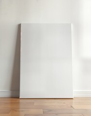 Poster - Blank white canvas leans against white wall on laminate floor. Interior design mockup. Versatile presentation template. Clean, modern aesthetic for home gallery. Empty space for artwork. Ready for