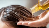 Woman applying hair oil to nourish and hydrate her long hair at home in a bright, modern bathroom