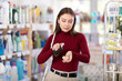 © JackF - Young woman buyer testing perfume in household chemicals store