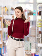© JackF - Young female shopper buying fragrance in household chemicals store