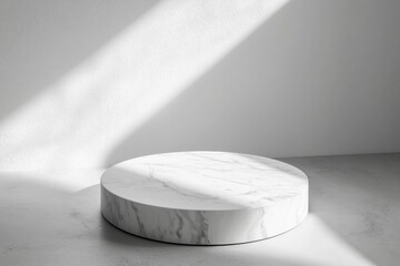 Poster - Round marble podium casting a subtle shadow on a gray floor in a sunlit minimalist studio, creating a serene and elegant backdrop, perfect for showcasing products