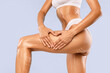 © Prostock-studio - Beauty, Lifting, Anti-age Concept. Closeup cropped view of young woman with massage lines and arrows on her body touching skin, making heart sign gesture with hands isolated on blue studio background